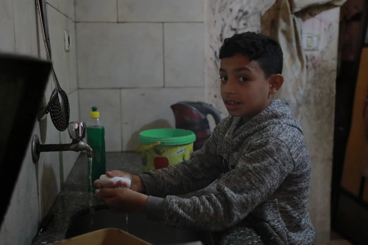 Hamza Zayed washing his hands