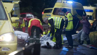 Ronny Frantzen (i rød jakke med ryggen til) og makkeren får sin pasient, som de skal frakte til sykehus.