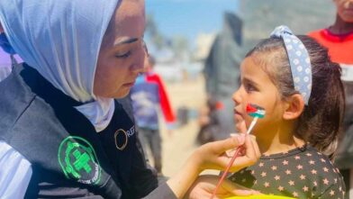 REFORMs frivillig maler et palestinsk flagg på en jente