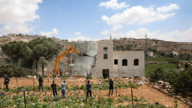 Israeli bulldozer demolishing house of Palestinian family in the West Bank