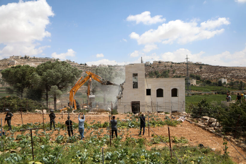 Israeli bulldozer demolishing house of Palestinian family in the West Bank